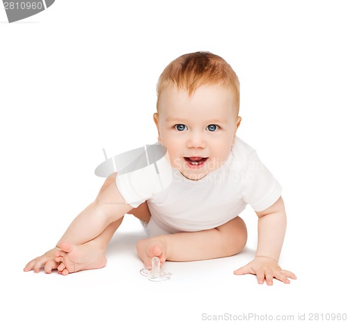 Image of smiling baby sitting on the floor