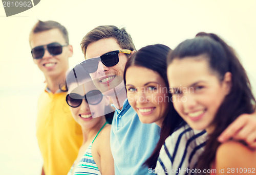 Image of group of friends having fun on the beach