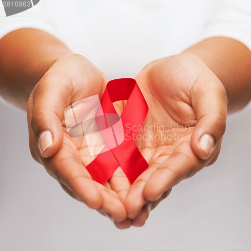 Image of hands holding red AIDS awareness ribbon