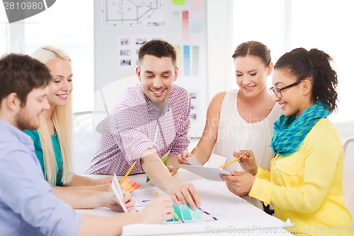 Image of smiling interior designers working in office