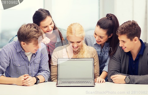 Image of smiling students looking at blank lapotop screen