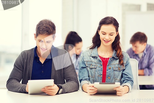 Image of students looking at tablet pc in lecture at school