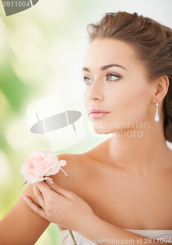 Image of young woman with rose flower