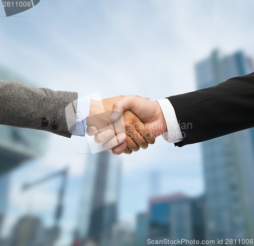 Image of businessman and businesswoman shaking hands