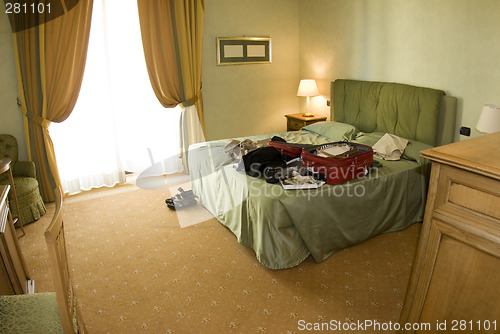 Image of hotel suite with open suitcase