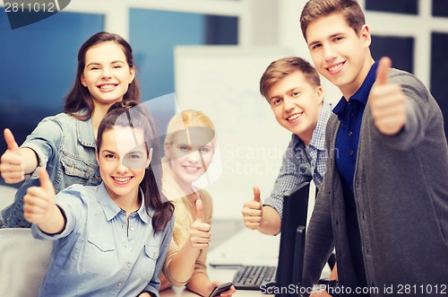 Image of students with computer monitor and smartphones