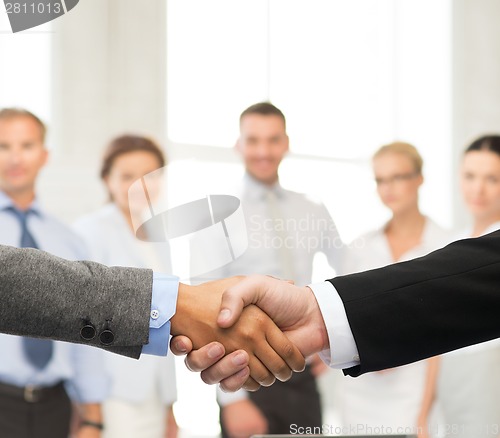 Image of businessman and businesswoman shaking hands