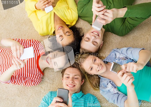 Image of group of smiling people lying down on floor