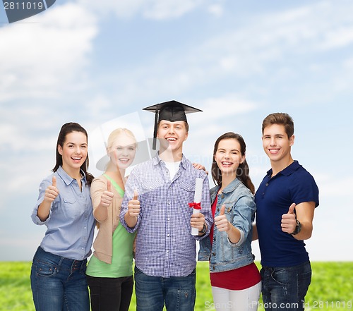 Image of group of students with diploma showing thumbs up