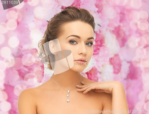 Image of woman wearing shiny diamond pendant