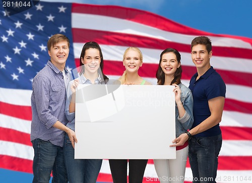 Image of group of standing students with blank white board