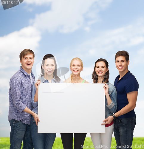 Image of group of standing students with blank white board