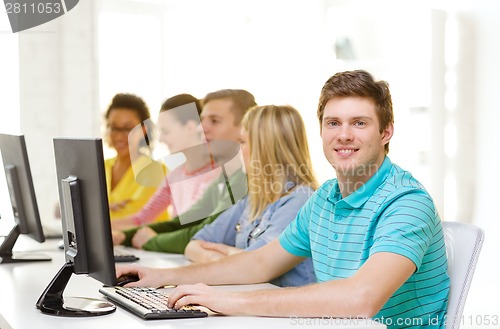 Image of male student with classmates in computer class