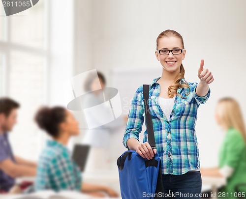 Image of student with laptop bag showing thumbs up