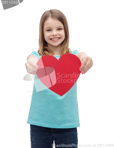 Image of smiling little girl giving red heart