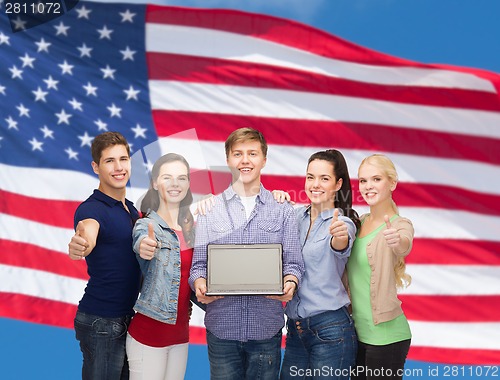 Image of smiling students with laptop computer