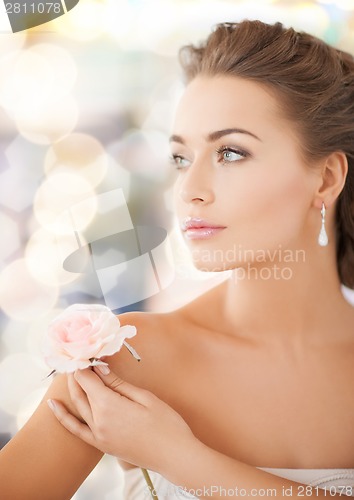 Image of young woman with rose flower