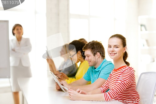 Image of female student with classmates in computer class