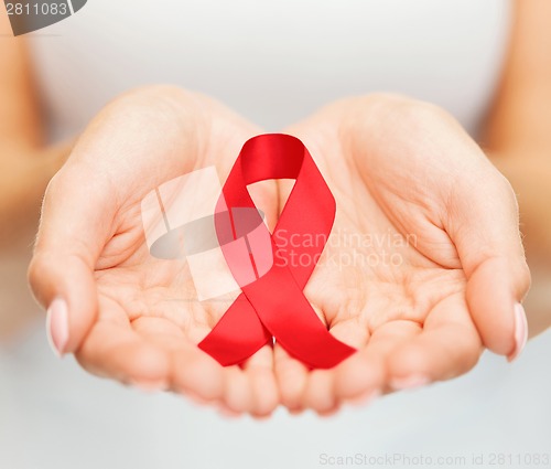 Image of hands holding red AIDS awareness ribbon