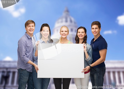 Image of group of standing students with blank white board