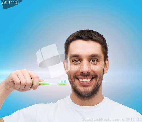 Image of smiling young man with toothbrush