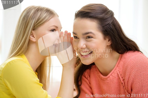 Image of one girl telling another secret