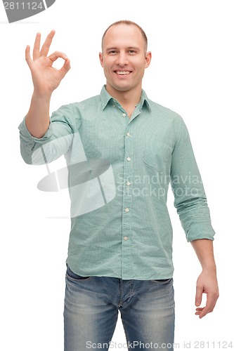 Image of smiling man showing ok-sign