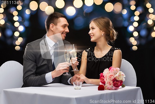 Image of couple with glasses of champagne at restaurant