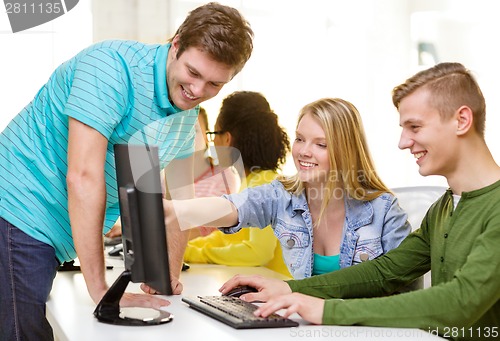 Image of smiling students in computer class at school