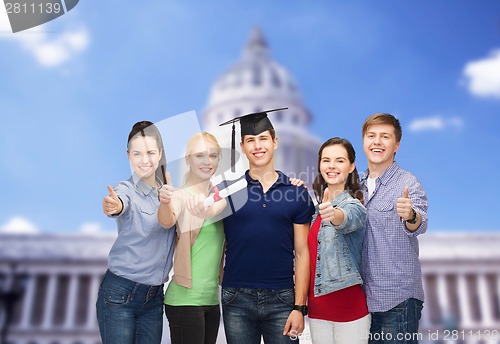 Image of group of students with diploma showing thumbs up