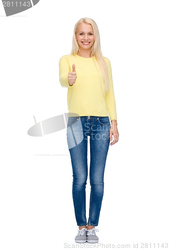 Image of smiling girl in casual clothes showing thumbs up