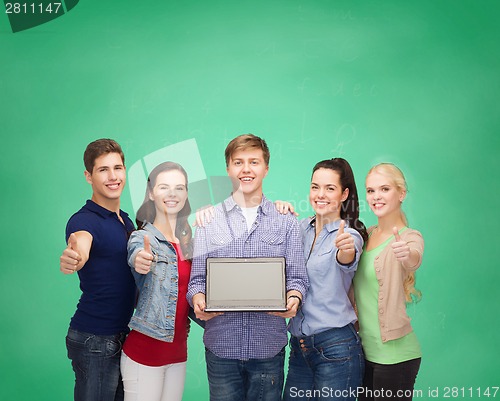 Image of smiling students with laptop computer