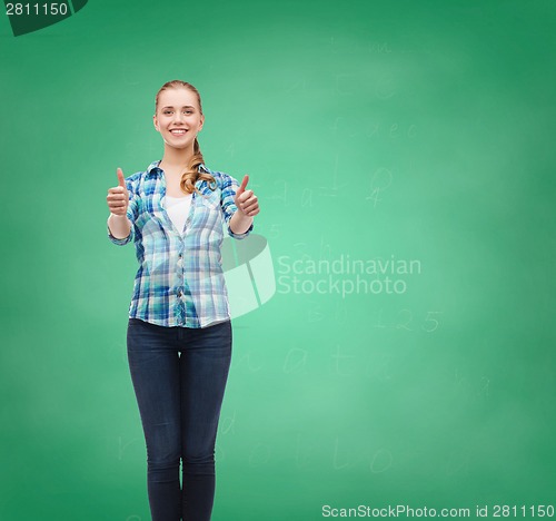 Image of young woman in casual clothes showing thumbs up