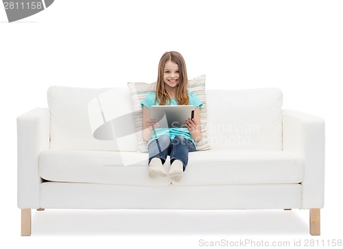 Image of little girl sitting on sofa with tablet pc comuter