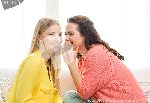 Image of one girl telling another secret