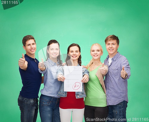 Image of group of students showing test and thumbs up