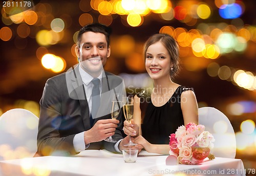 Image of couple with glasses of champagne at restaurant