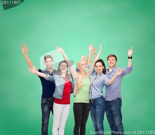 Image of group of smiling students waving hands