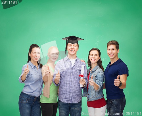 Image of group of students with diploma showing thumbs up