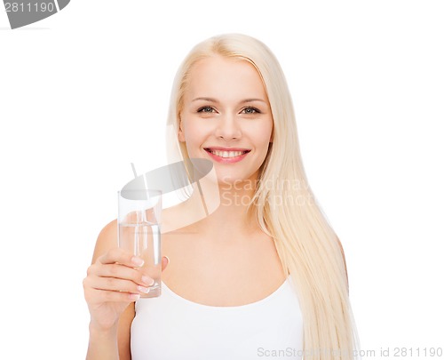 Image of young smiling woman with glass of water