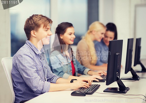 Image of students looking at computer monitor at school