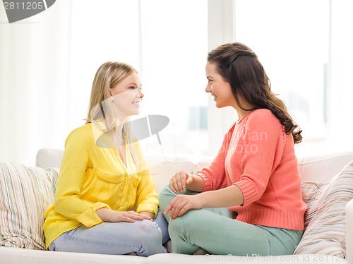 Image of two girlfriends having a talk at home