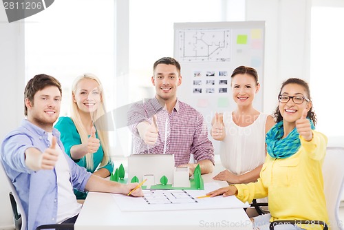 Image of smiling architects working in office