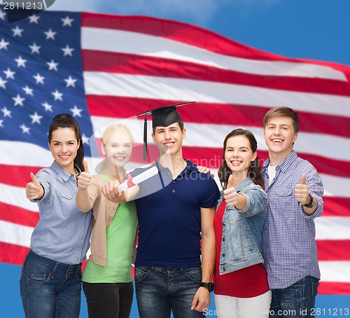 Image of group of students with diploma showing thumbs up