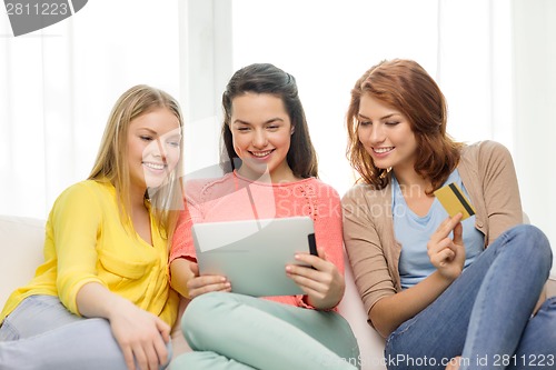 Image of teenage girls with tablet pc and credit card