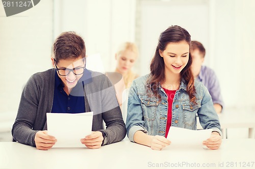 Image of two teenagers looking at test or exam results