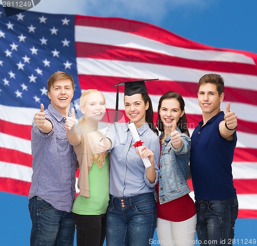 Image of group of students with diploma showing thumbs up