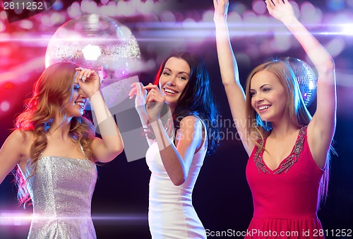 Image of three smiling women dancing in the club