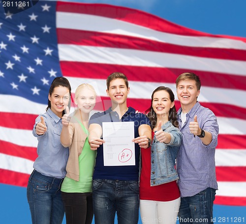 Image of group of students showing test and thumbs up