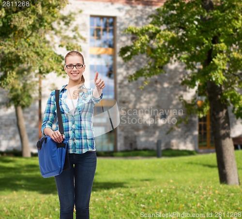 Image of student with laptop bag showing thumbs up